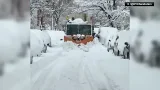 New York City Sanitation snowplow clears snow-covered road