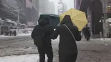 People in Times Square walking through snow during winter storm