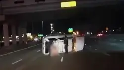 Woman's rescue from overturned vehicle caught on camera.